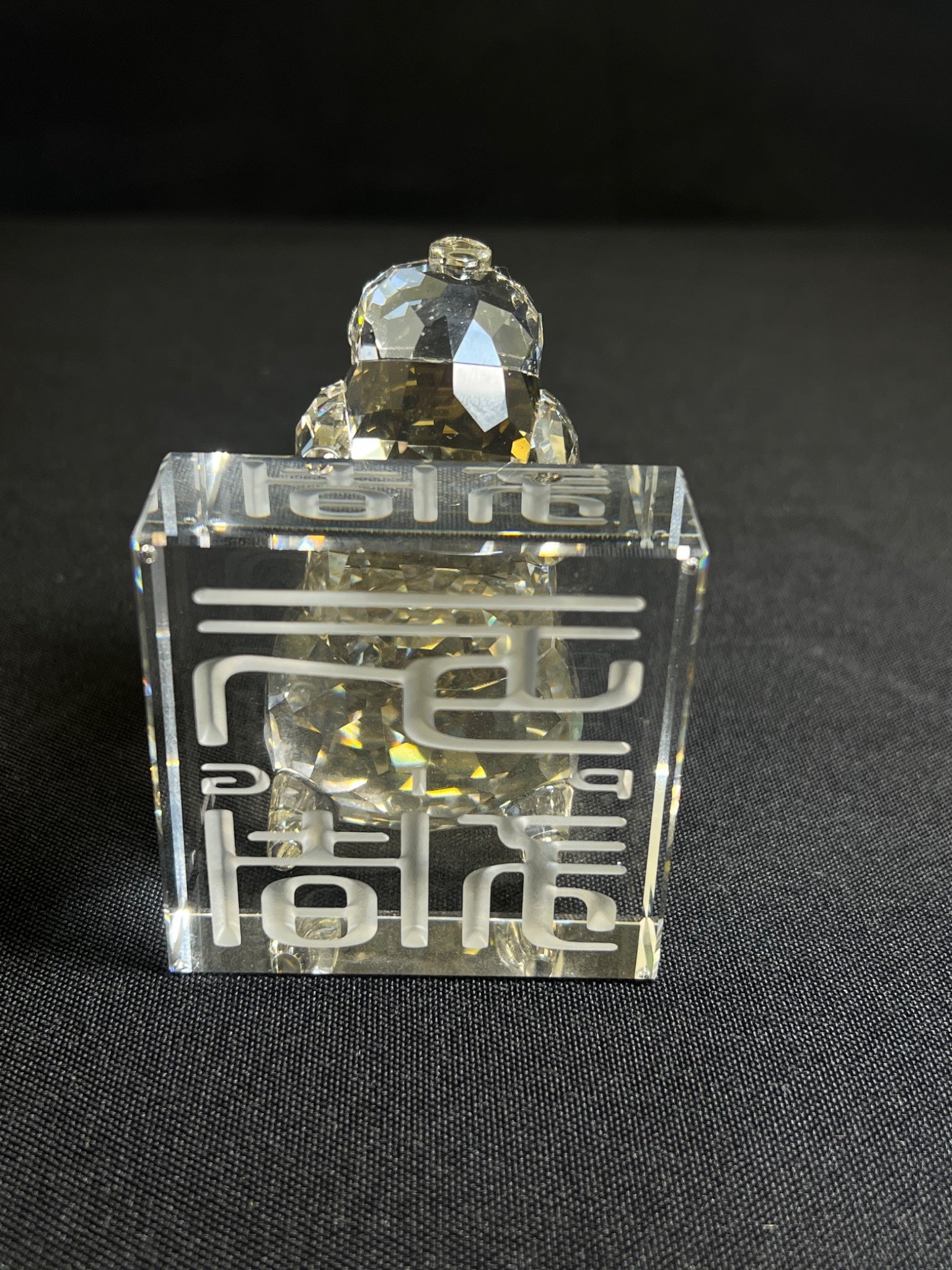 Clear crystal object with geometric design on a black background