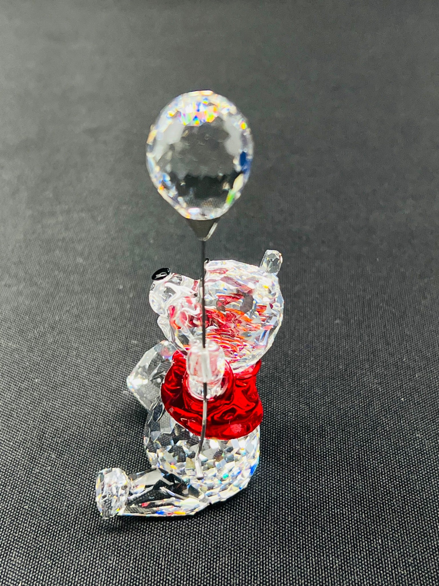Crystal bear figurine with a bubble on a gray background