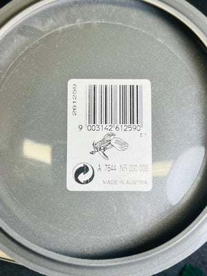 Close-up of a metal container lid with a barcode label.