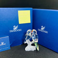 Swarovski crystal figurine of two birds on a branch with blue packaging and certificate.