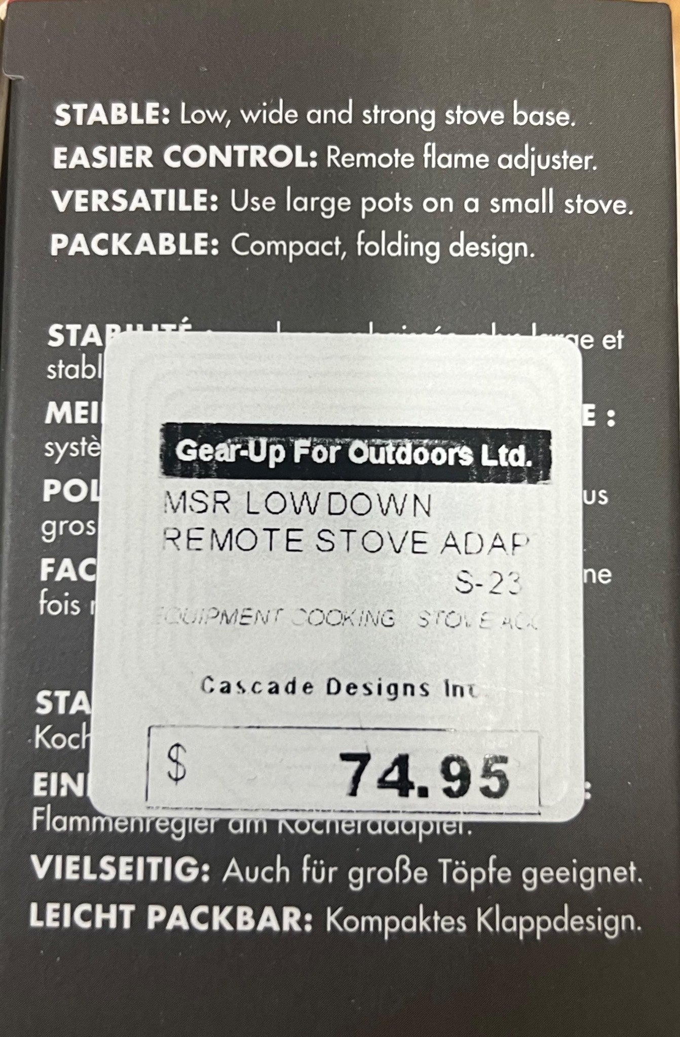 Product packaging with a label for MSR Low Down Remote Stove Adapter on a black background.