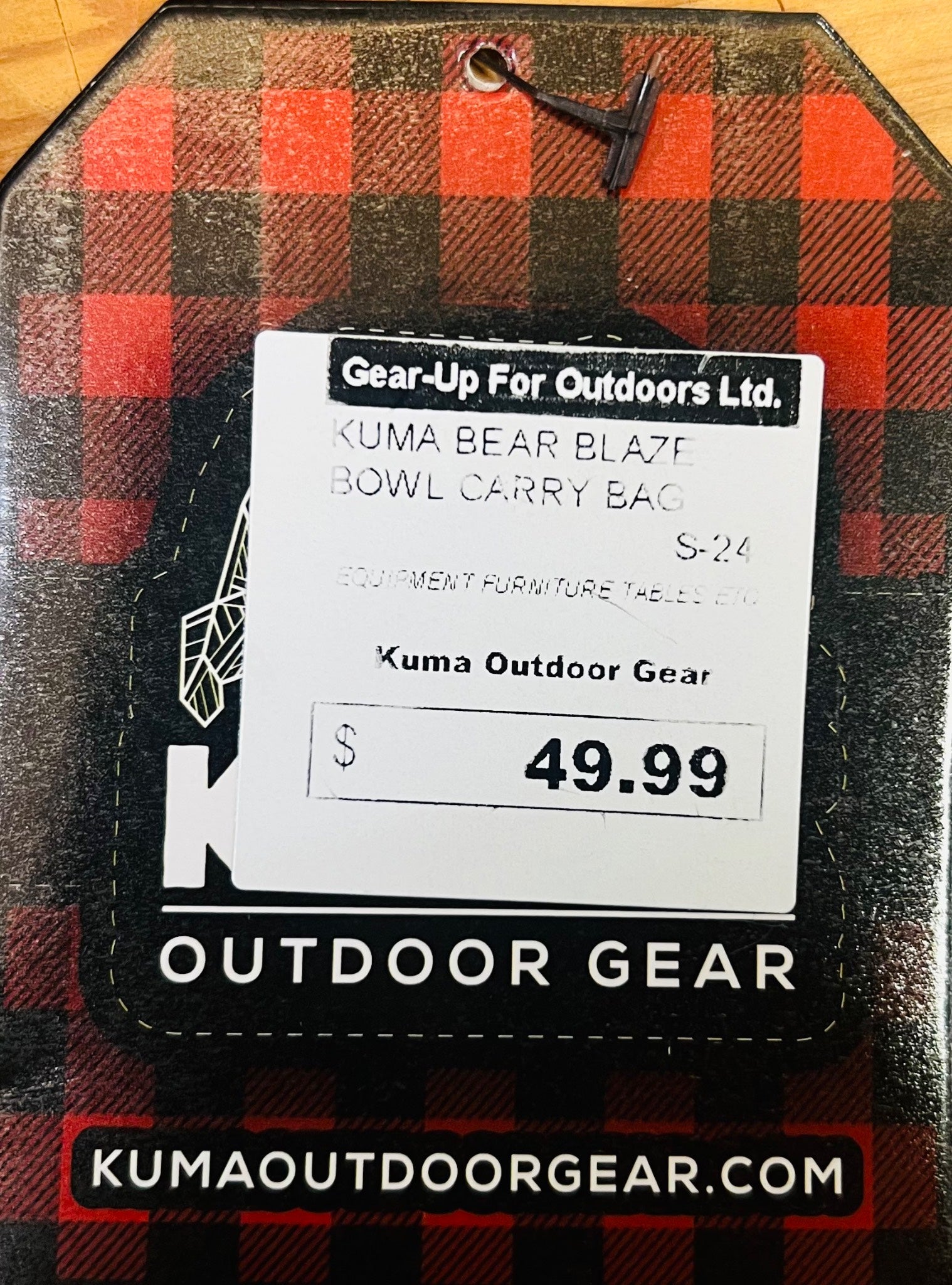 Kuma Outdoor Gear tag on a plaid bag with product details and price.