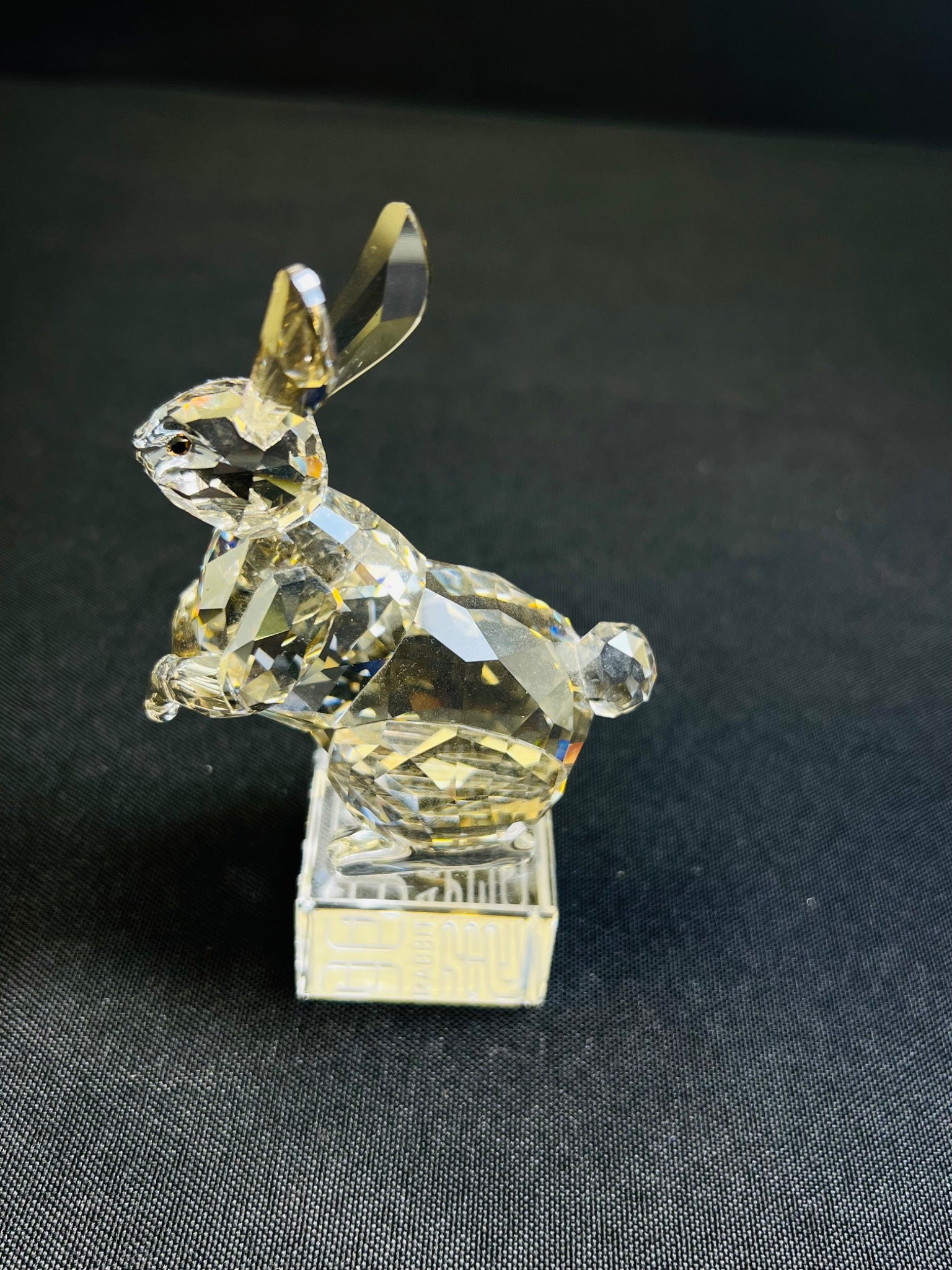 Crystal rabbit figurine on a black background