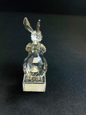 Crystal rabbit figurine on a black background