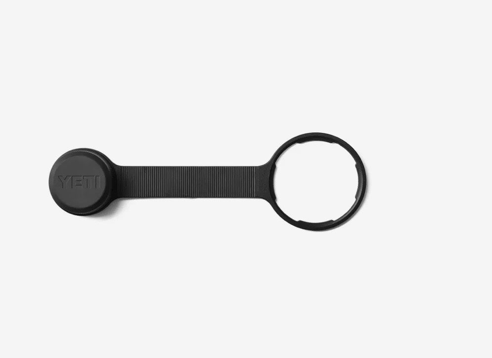 Black keychain device with a circular tag on a white background