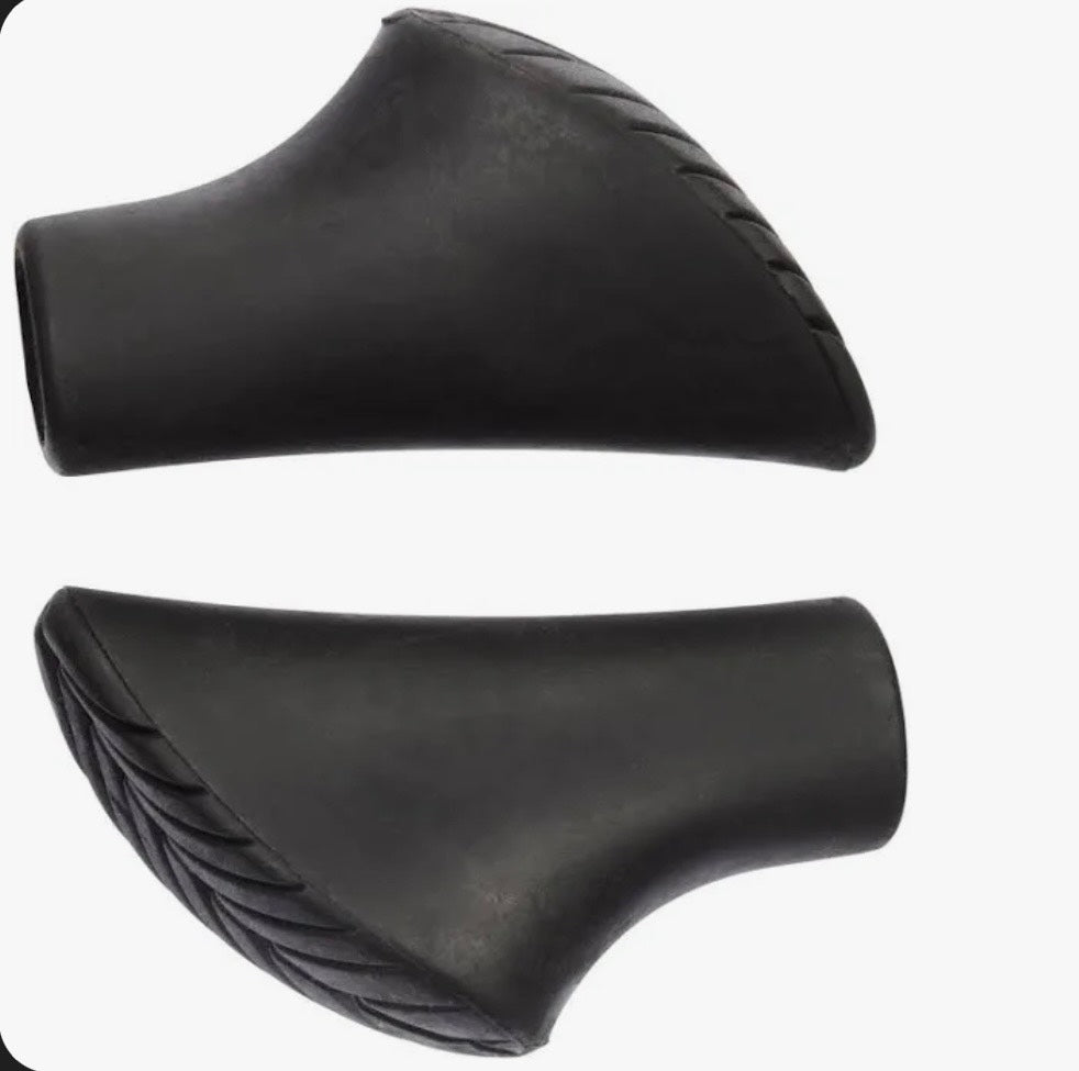 Two black leather motorcycle seat covers on a white background