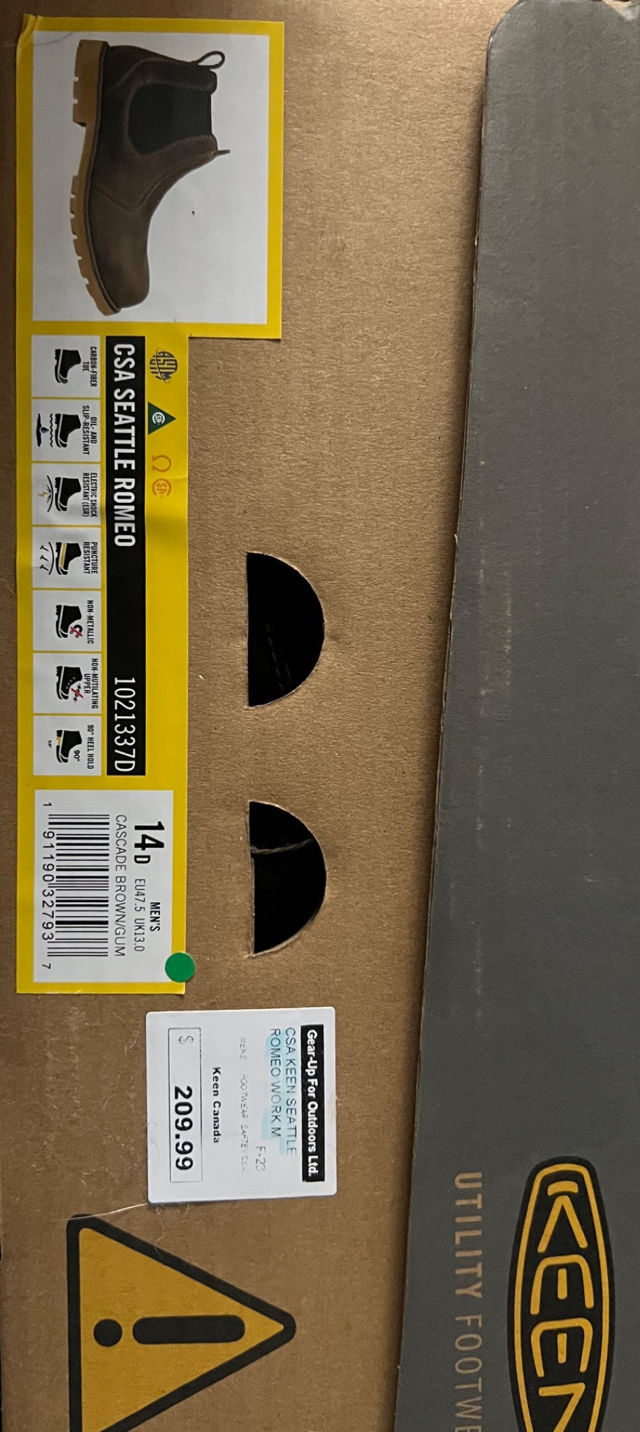 Cardboard box with a boot on top, featuring Klim branding and safety symbols.
