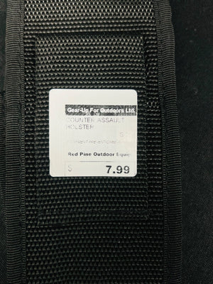 Black tactical holster with a label on a black background