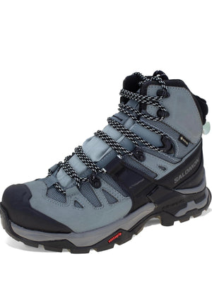 Gray hiking boot with black laces on a white background