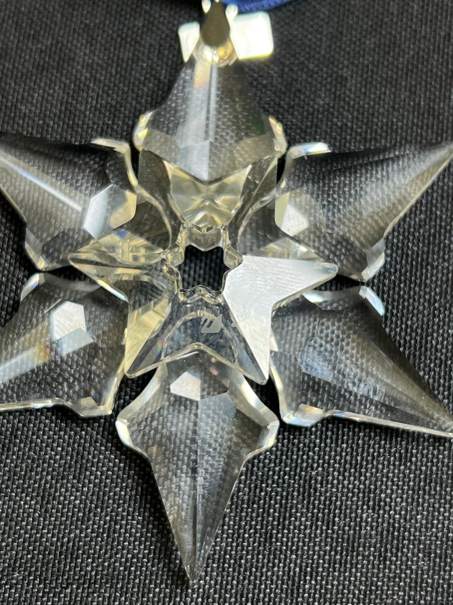 Crystal snowflake ornament on a black background