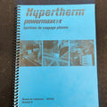 Blue manual with Hypertherm branding on a brown surface