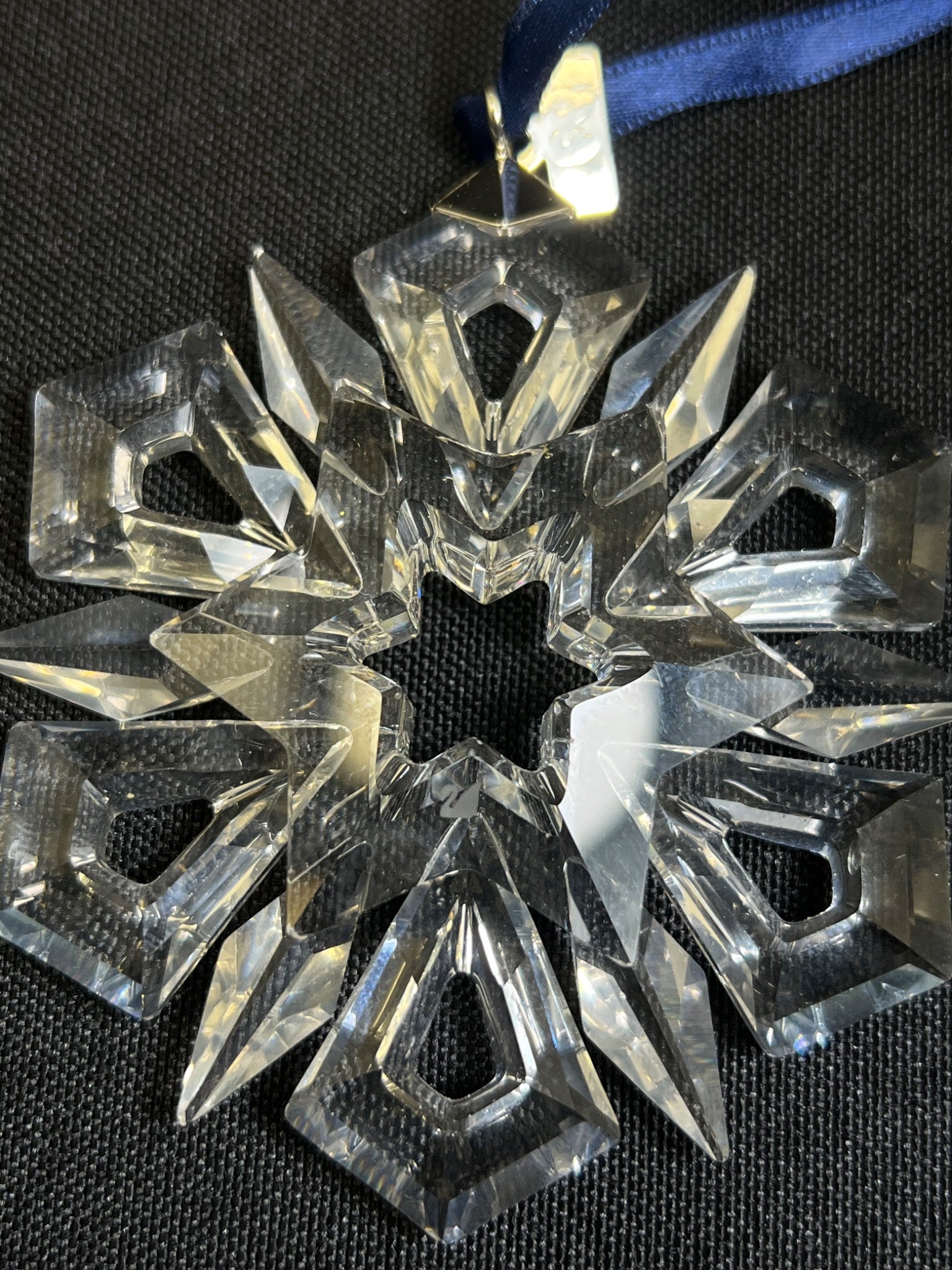Crystal snowflake ornament on a black background
