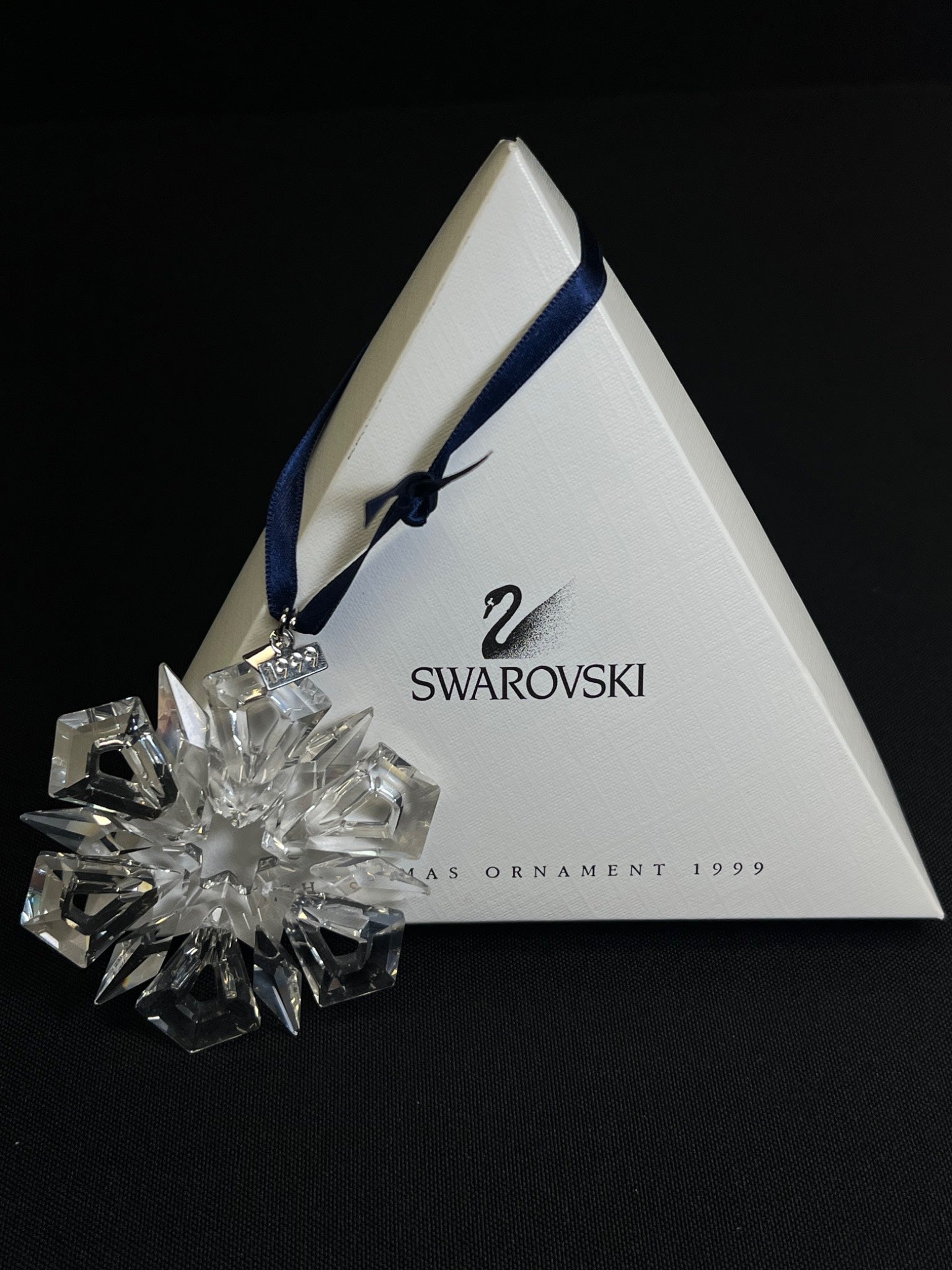 Swarovski crystal ornament with packaging on a black background