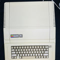 Vintage Apple II computer on a black background