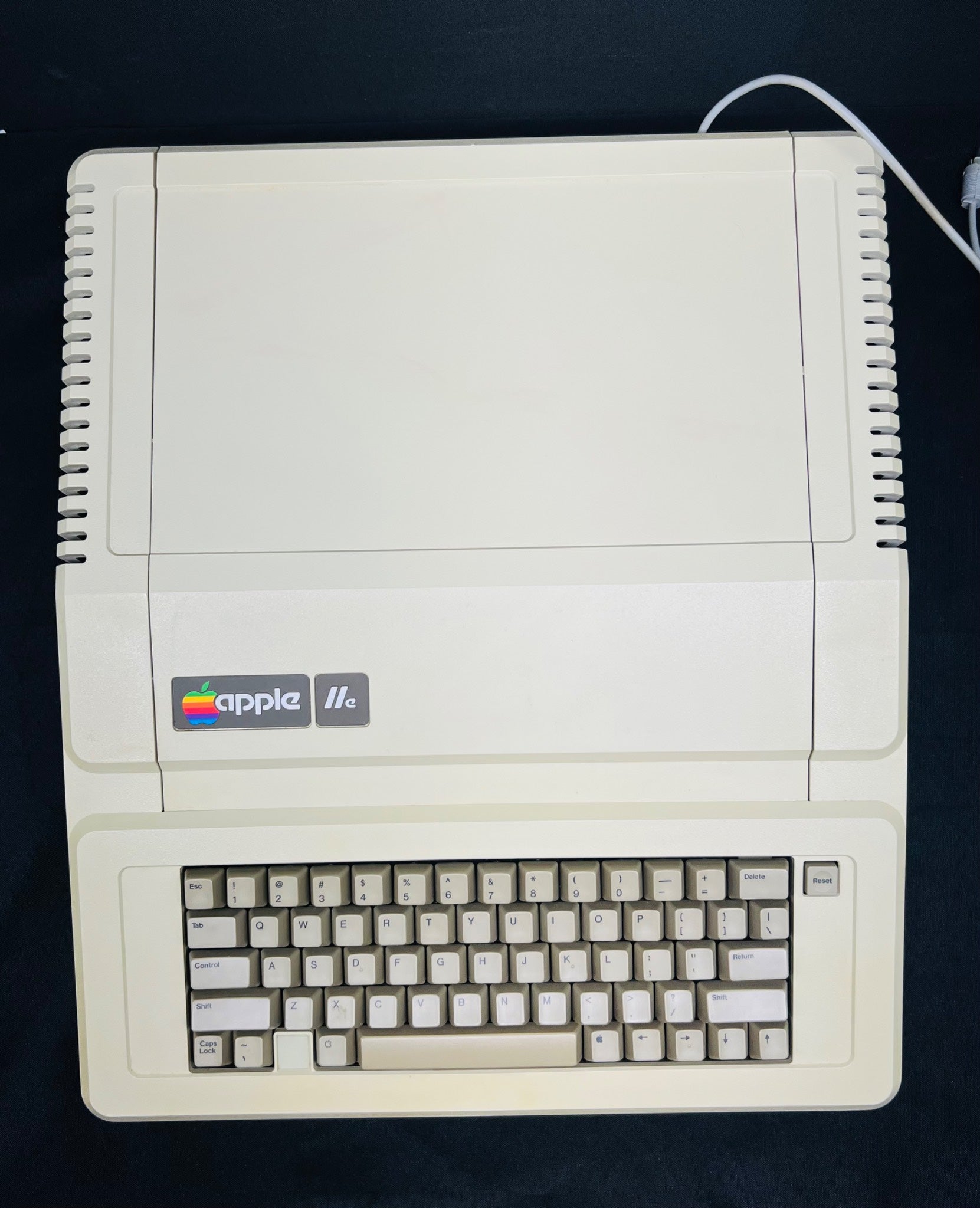 Vintage Apple II computer on a black background
