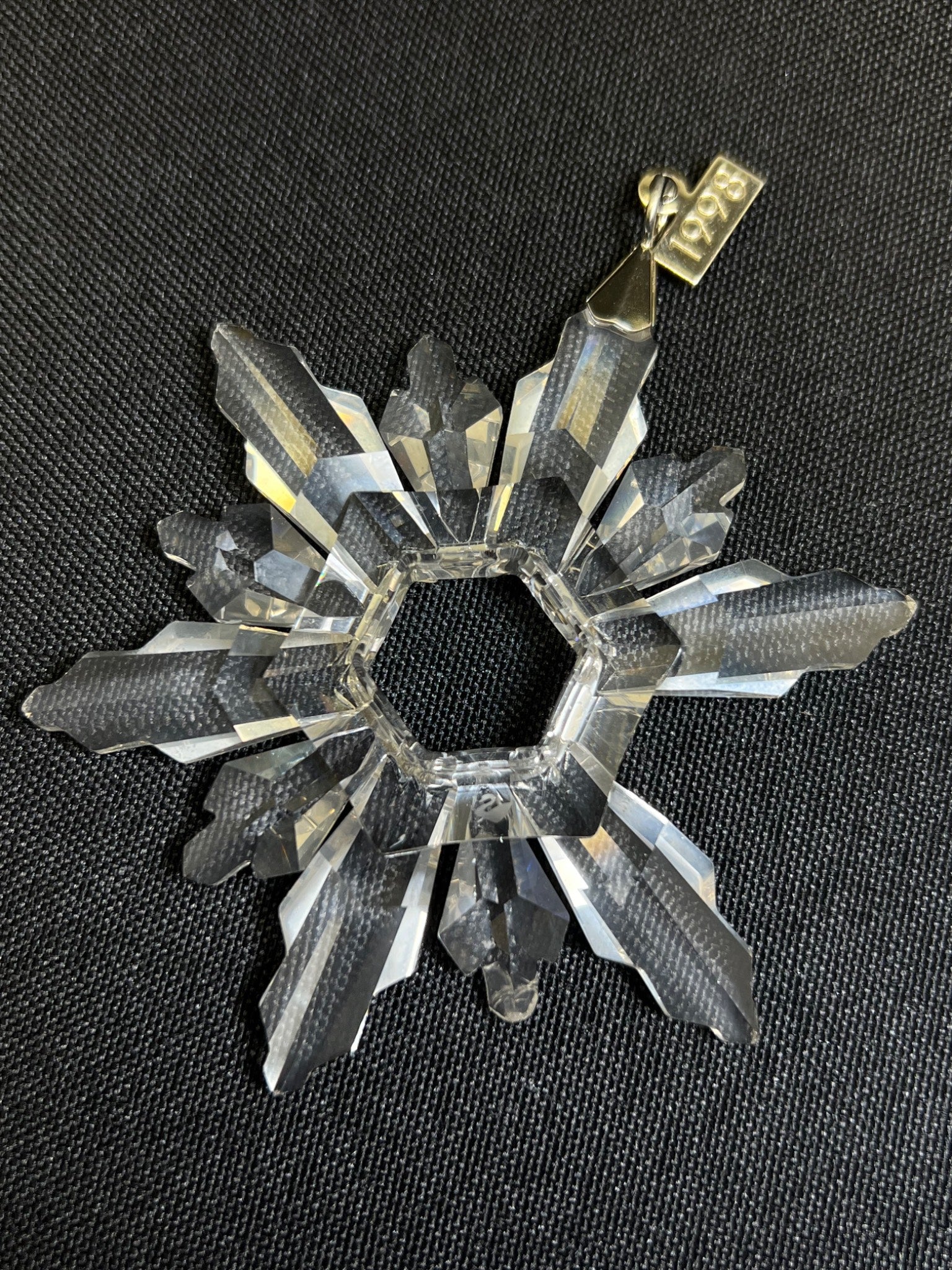 Crystal snowflake ornament on a black background