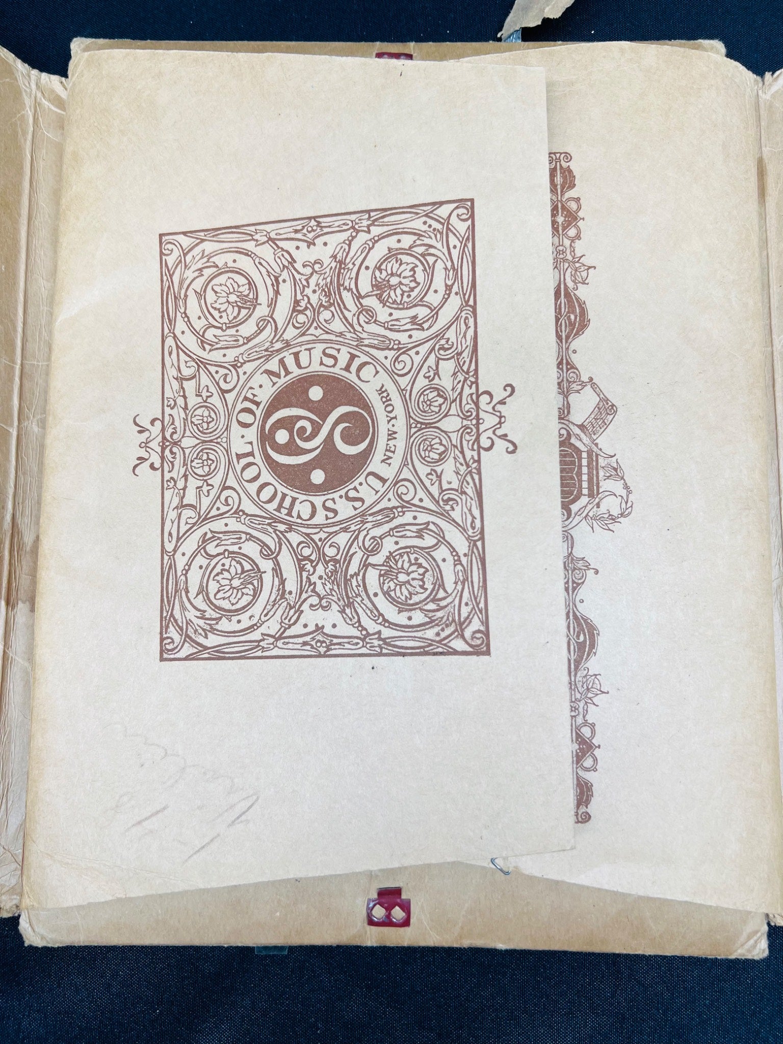 Vintage book with decorative cover and text on a dark background