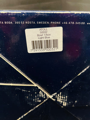 Close-up of a product label on a dark surface with visible text and bar code.