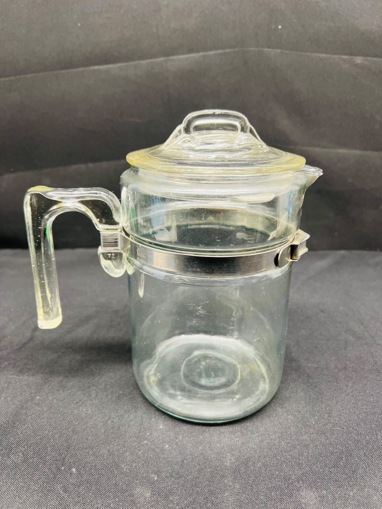 Clear glass jar with a lid on a gray background