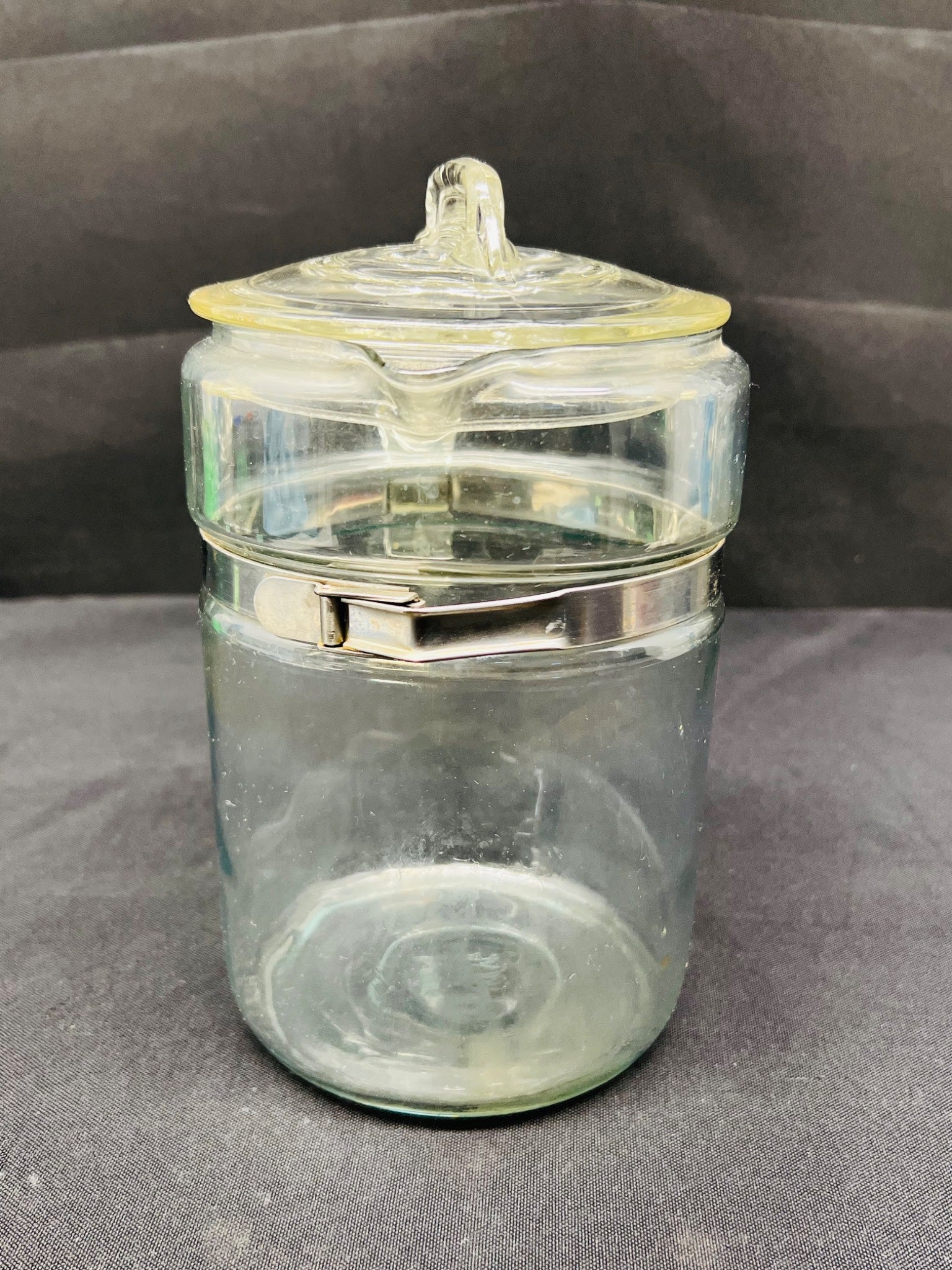 Clear glass jar with a lid on a gray background