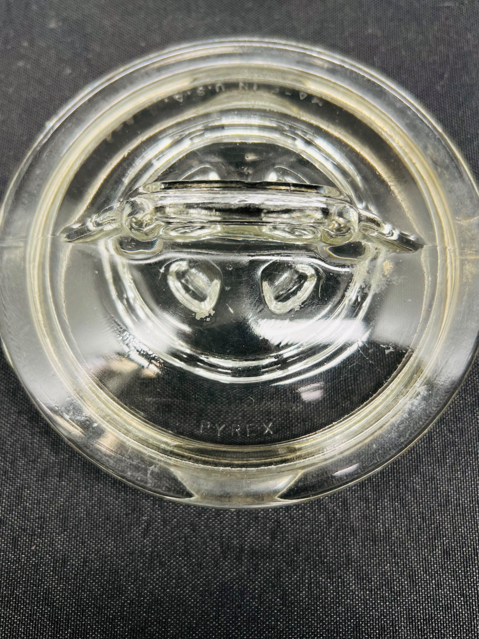 Clear glass object on a dark fabric background