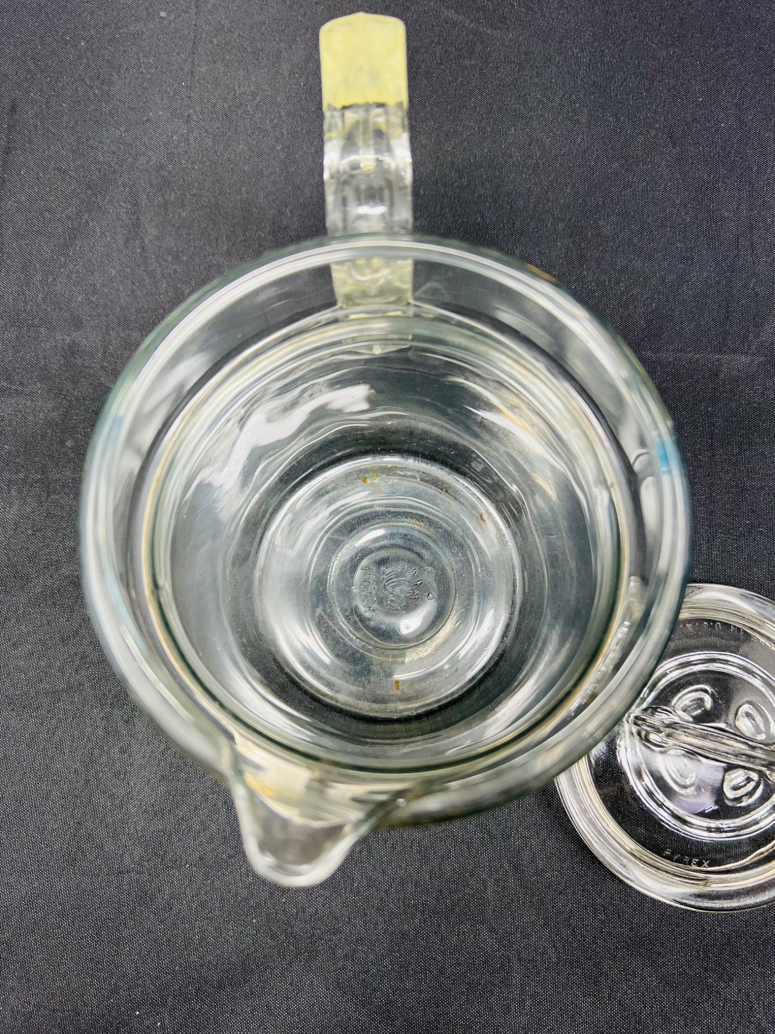 Clear glass mug with handle on a dark background