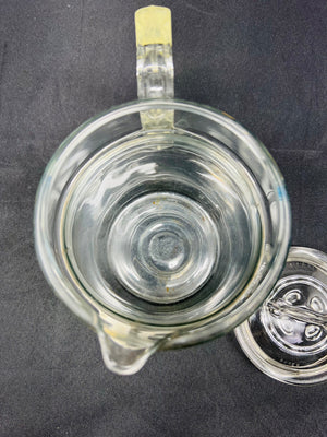 Clear glass mug with handle on a dark background