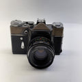Vintage camera with a prominent lens on a white background