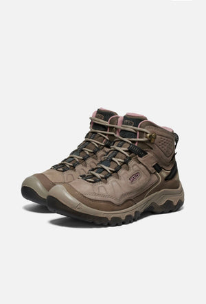 Pair of brown hiking boots on a white background