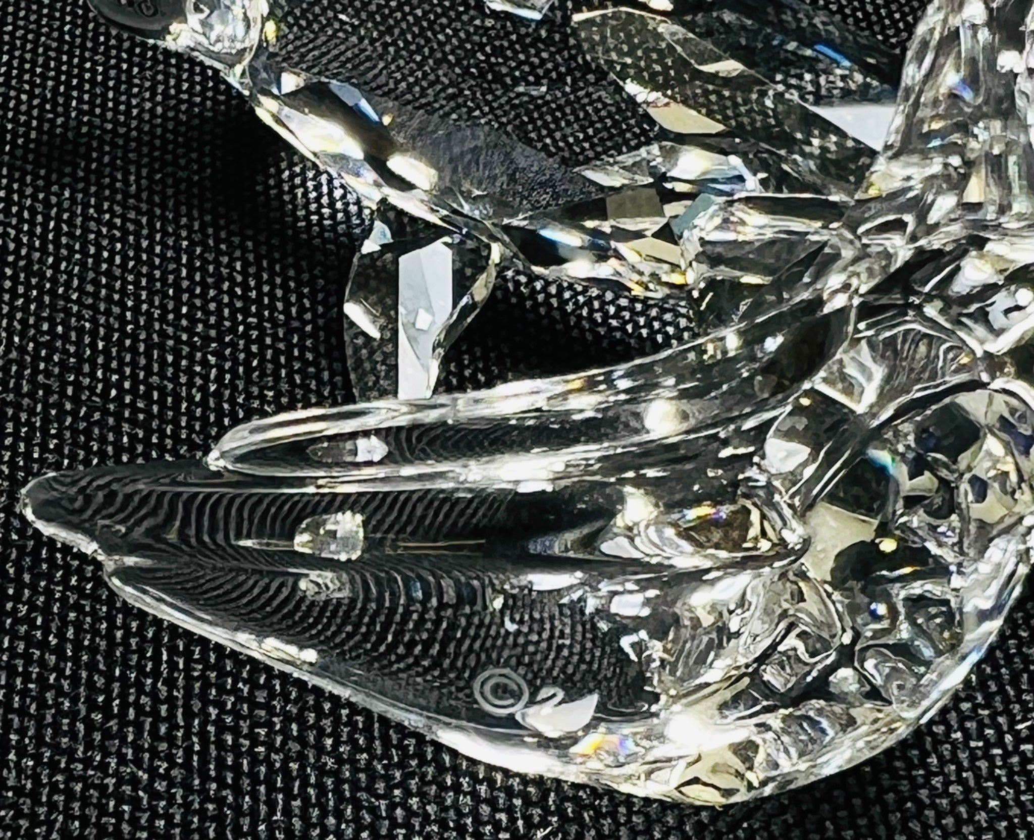 Crystal butterfly figurine on a black textured background