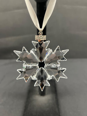 Crystal snowflake ornament with '2018' on a black background