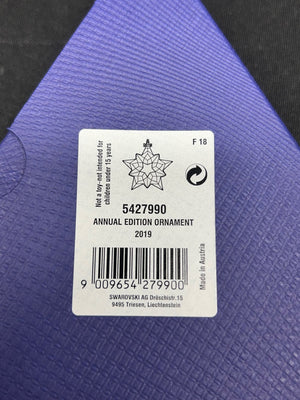 Label on a purple textured surface with product details.