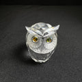 Crystal owl figurine on a black background