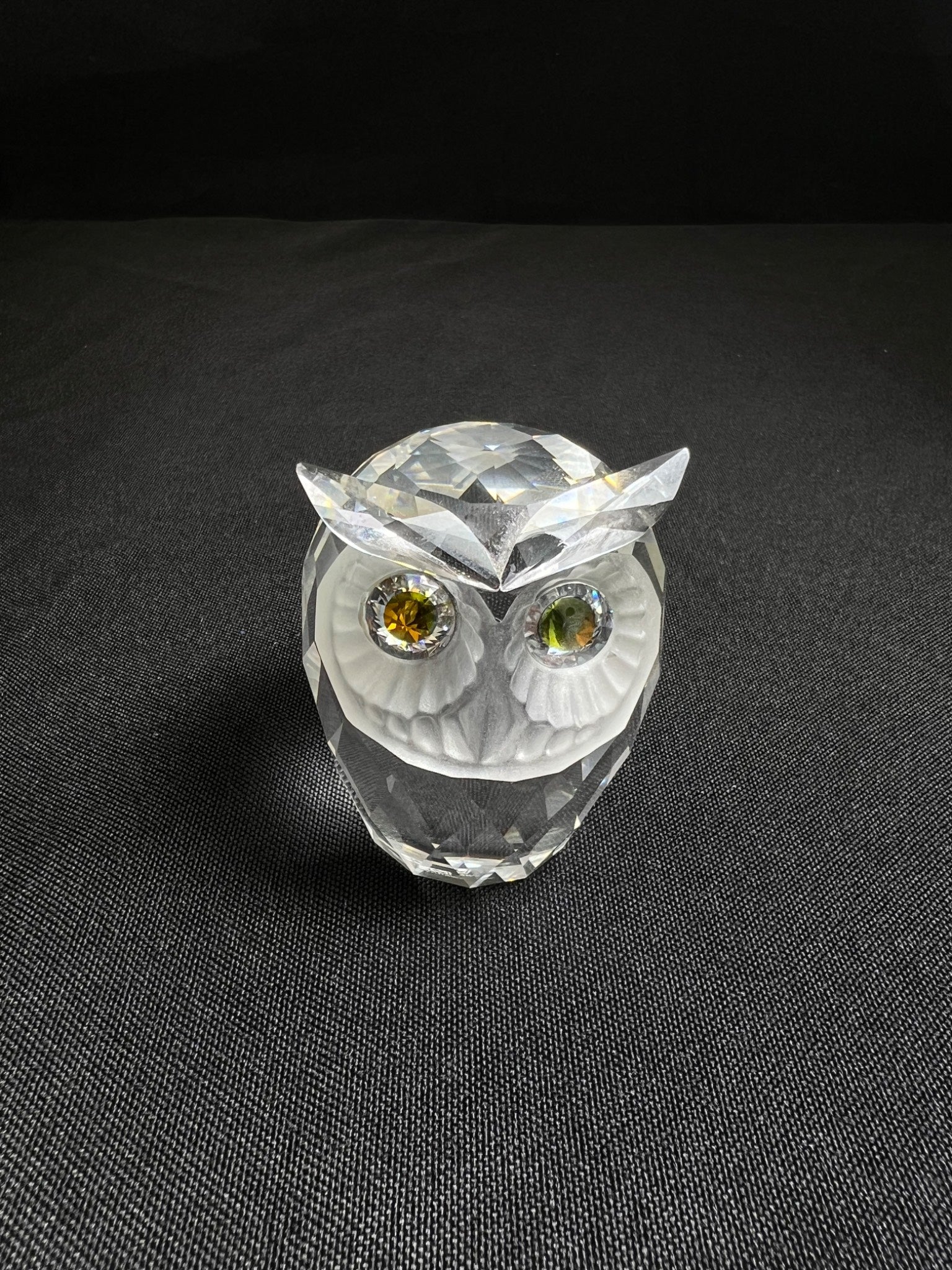 Crystal owl figurine on a black background