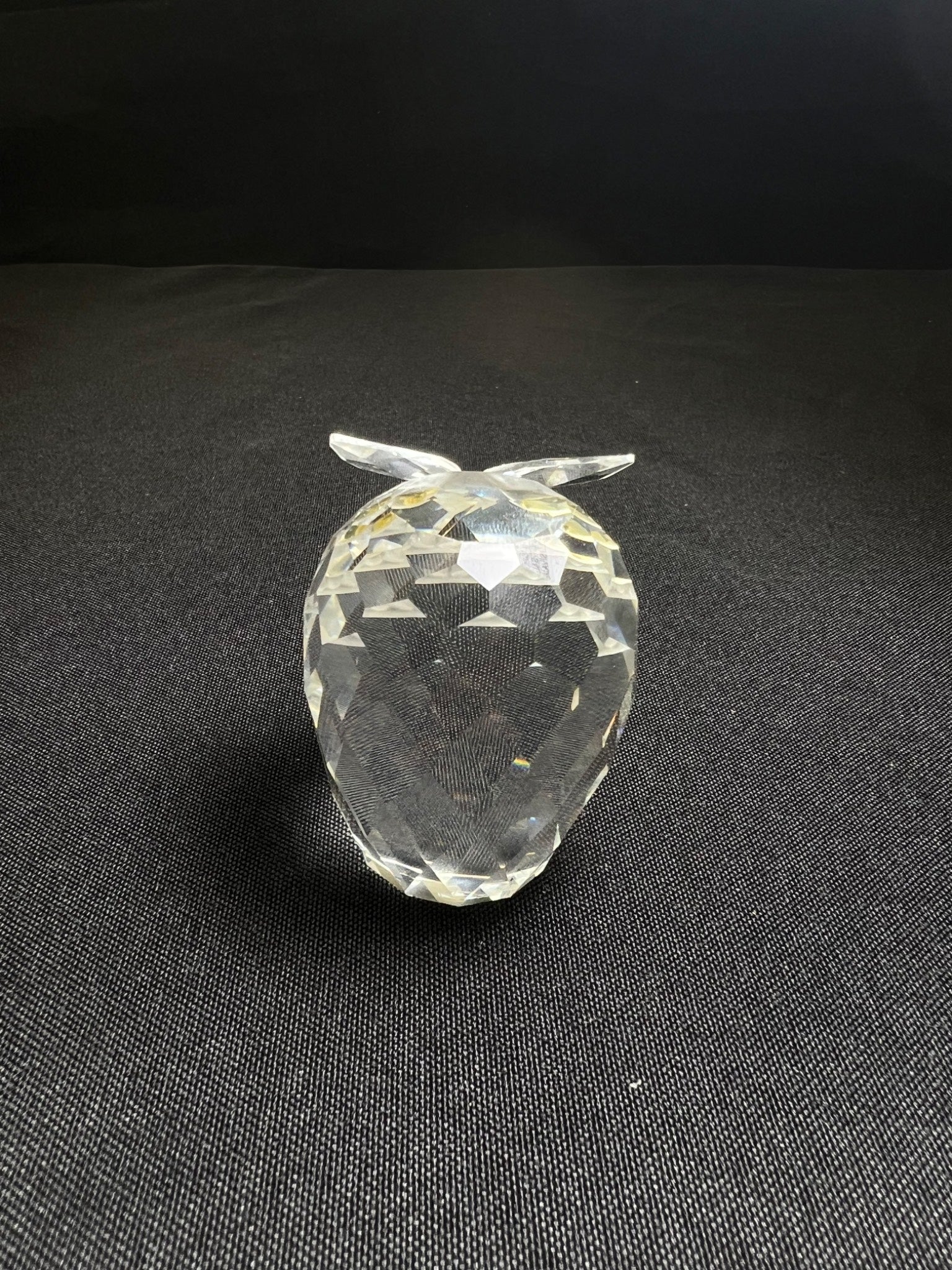 Clear crystal pineapple figurine on a black background