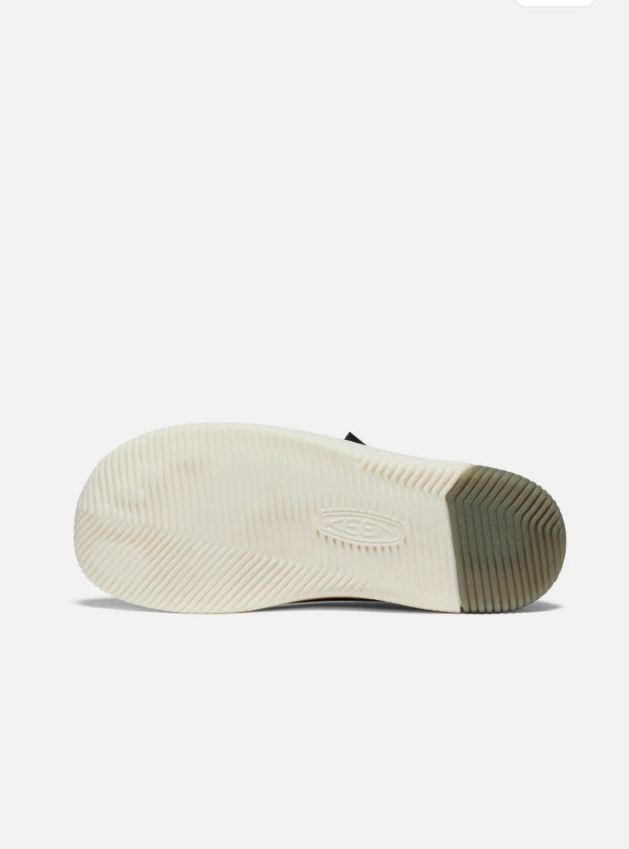 Close-up of a shoe sole with a white sole and brown sole on a light gray background