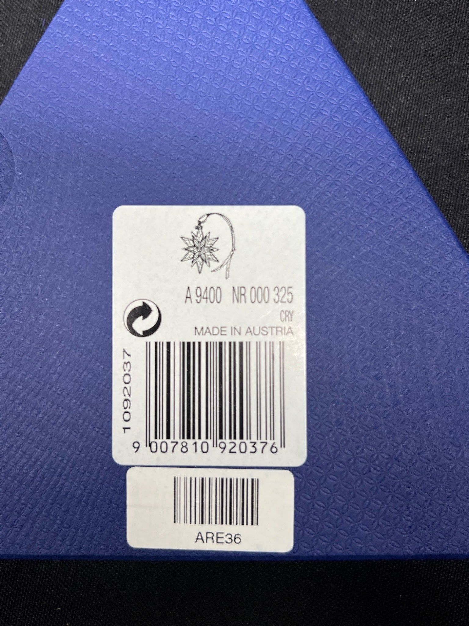 Product label with barcode and text on a blue textured background