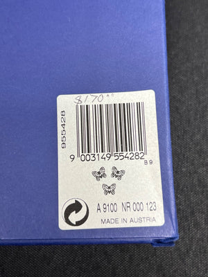 Bar code label on a blue surface with text and symbols.