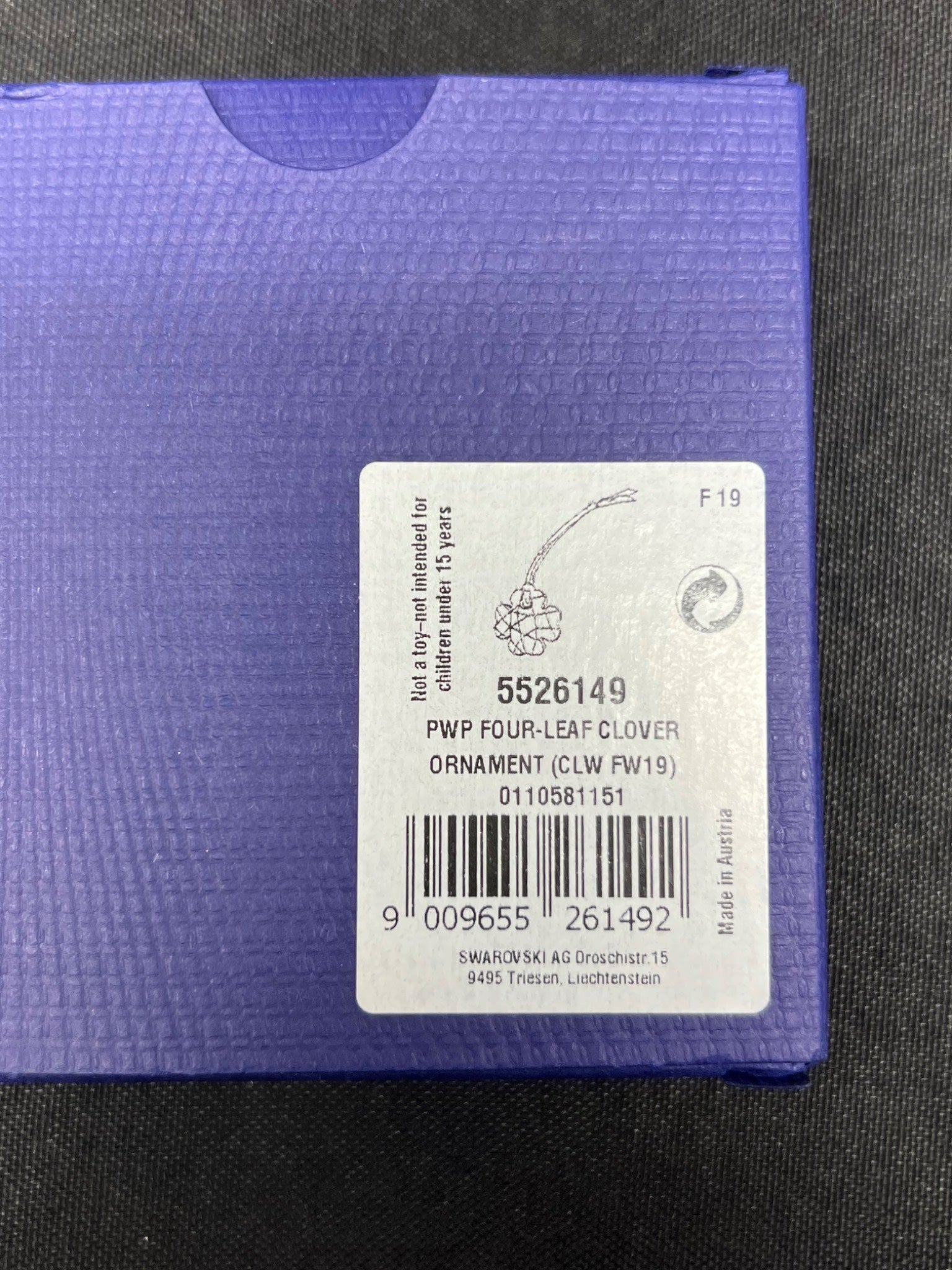 Purple product packaging with a label on a black background