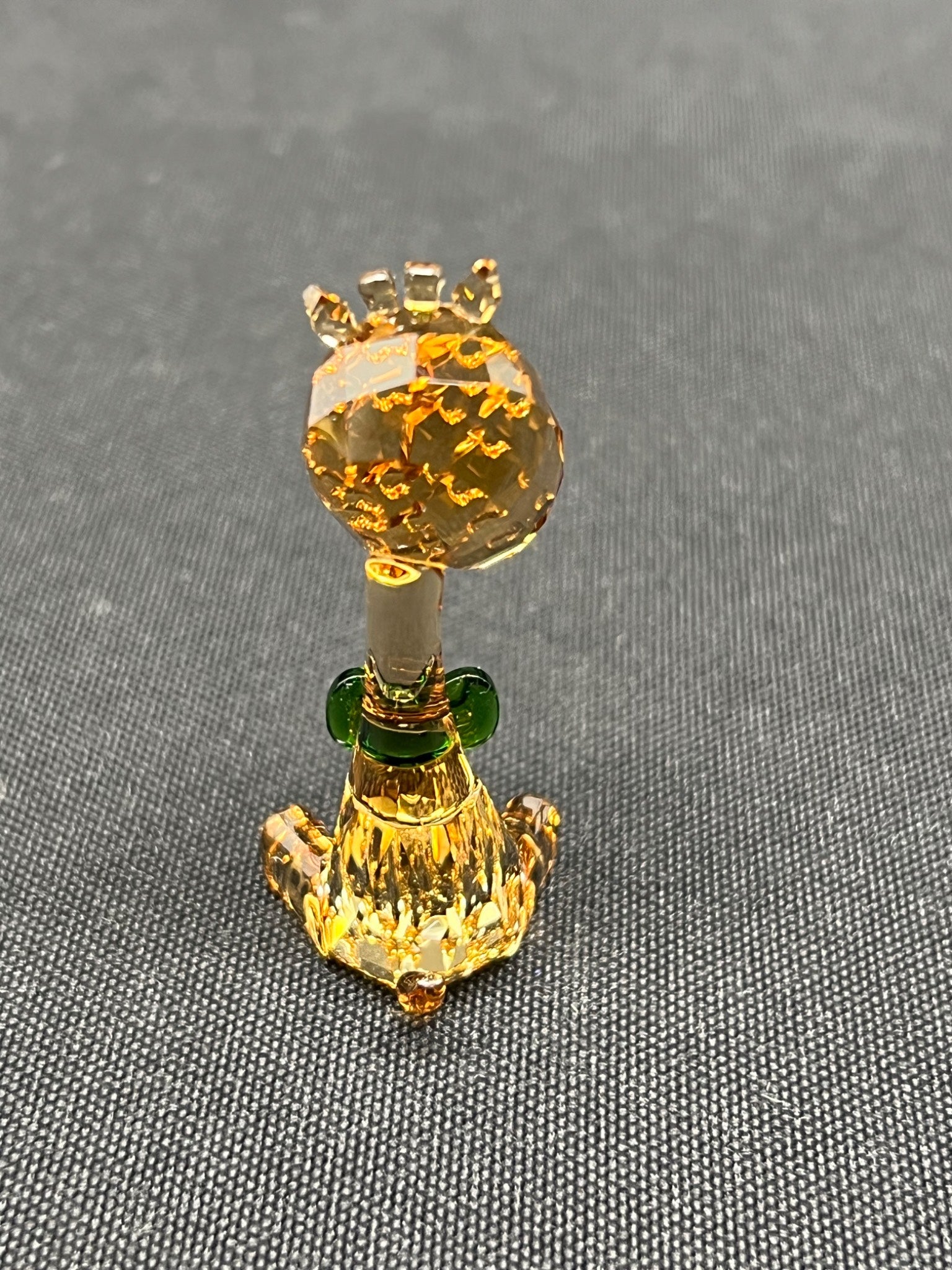 Decorative item resembling a pineapple with a crown on a gray background