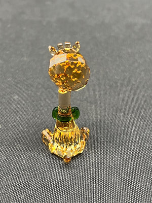 Decorative item resembling a pineapple with a crown on a gray background