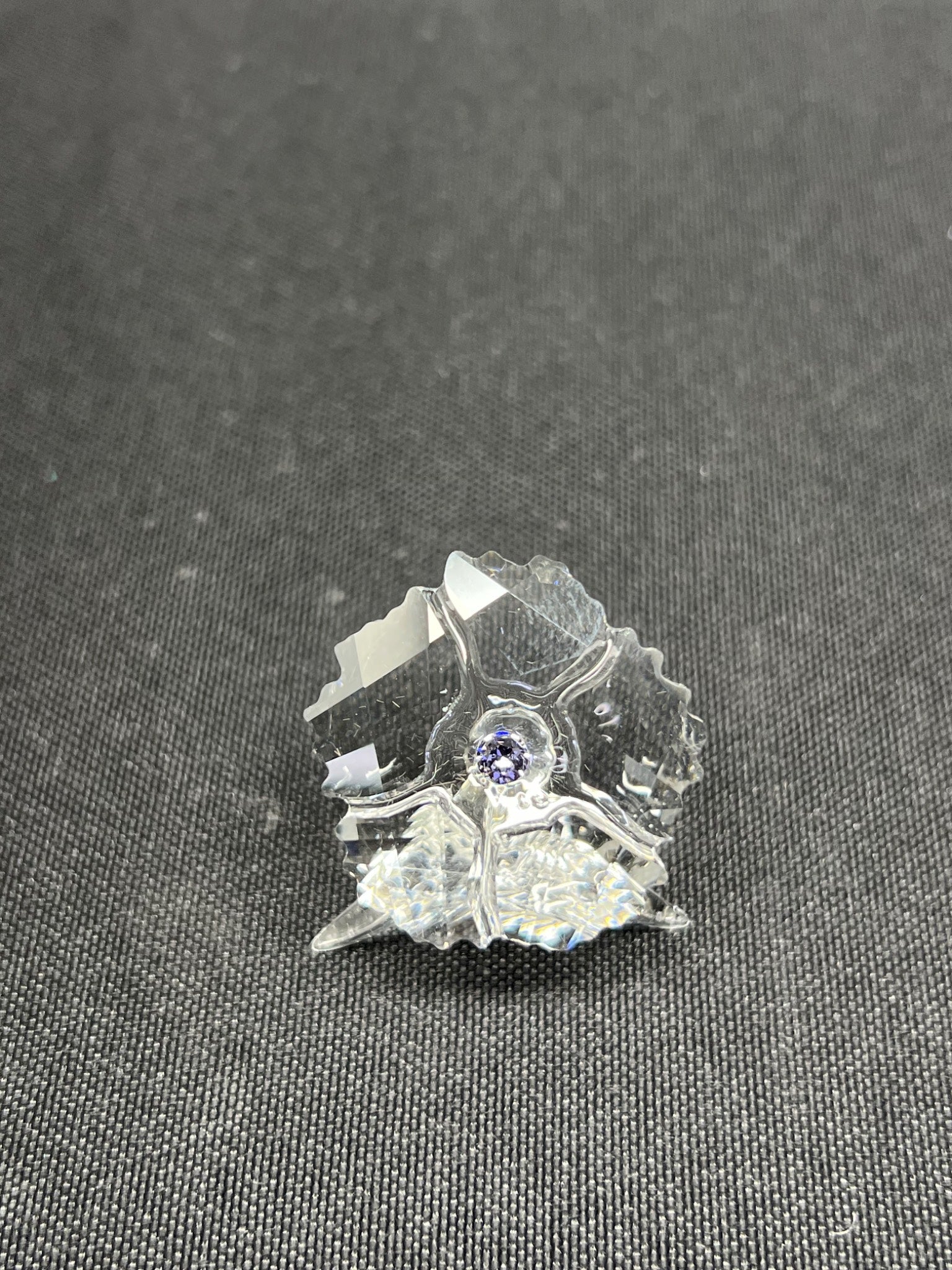 Crystal butterfly figurine on a dark textured surface