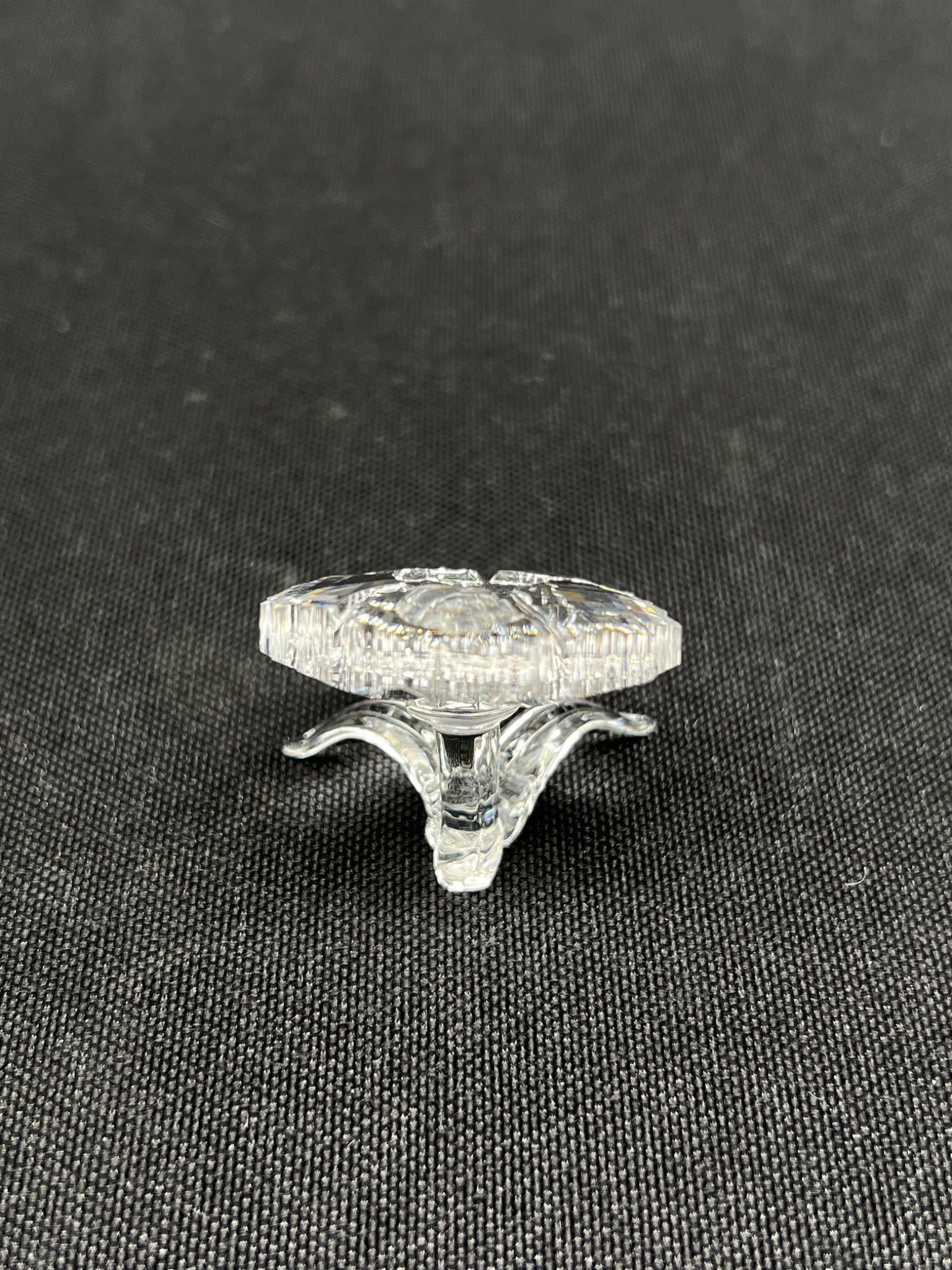 Clear glass knob on a black textured background