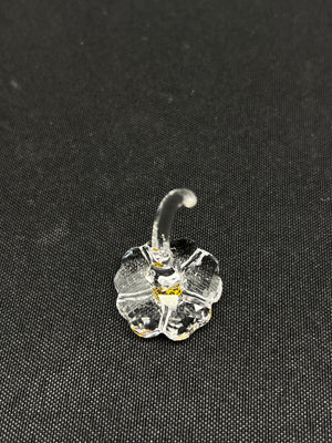 Clear glass flower-shaped object on a black background