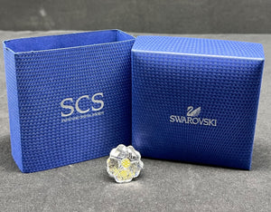 Blue Swarovski jewelry box with a crystal on a gray surface