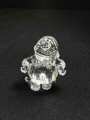 Crystal figurine of a small creature on a black background