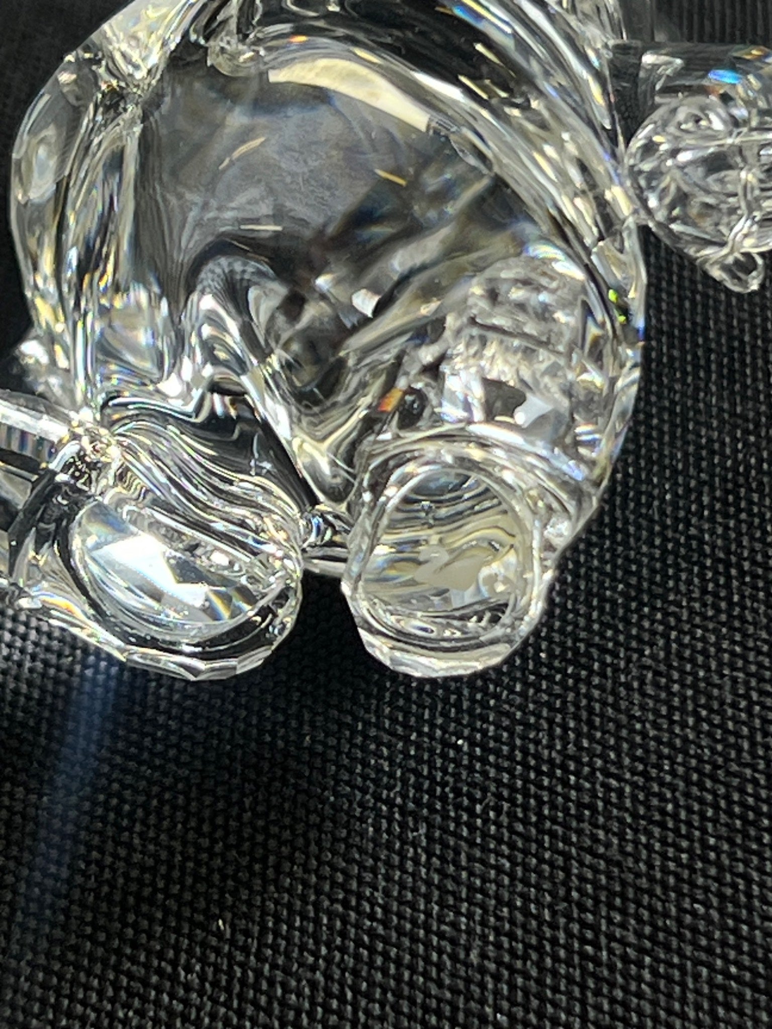 Close-up of a clear glass object on a textured black surface