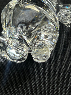 Close-up of a clear glass object on a textured black surface