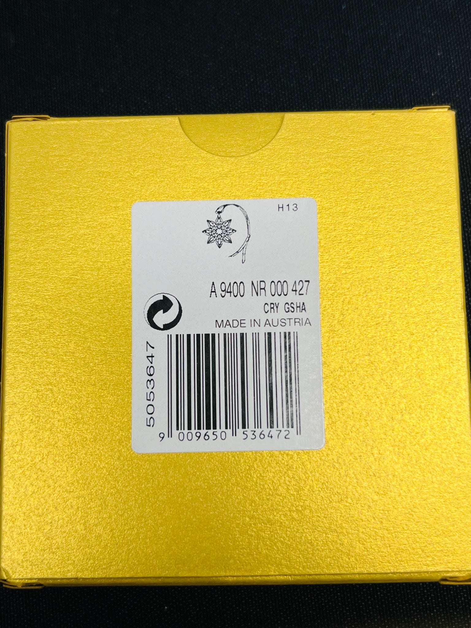 Yellow product packaging with a label on a black background