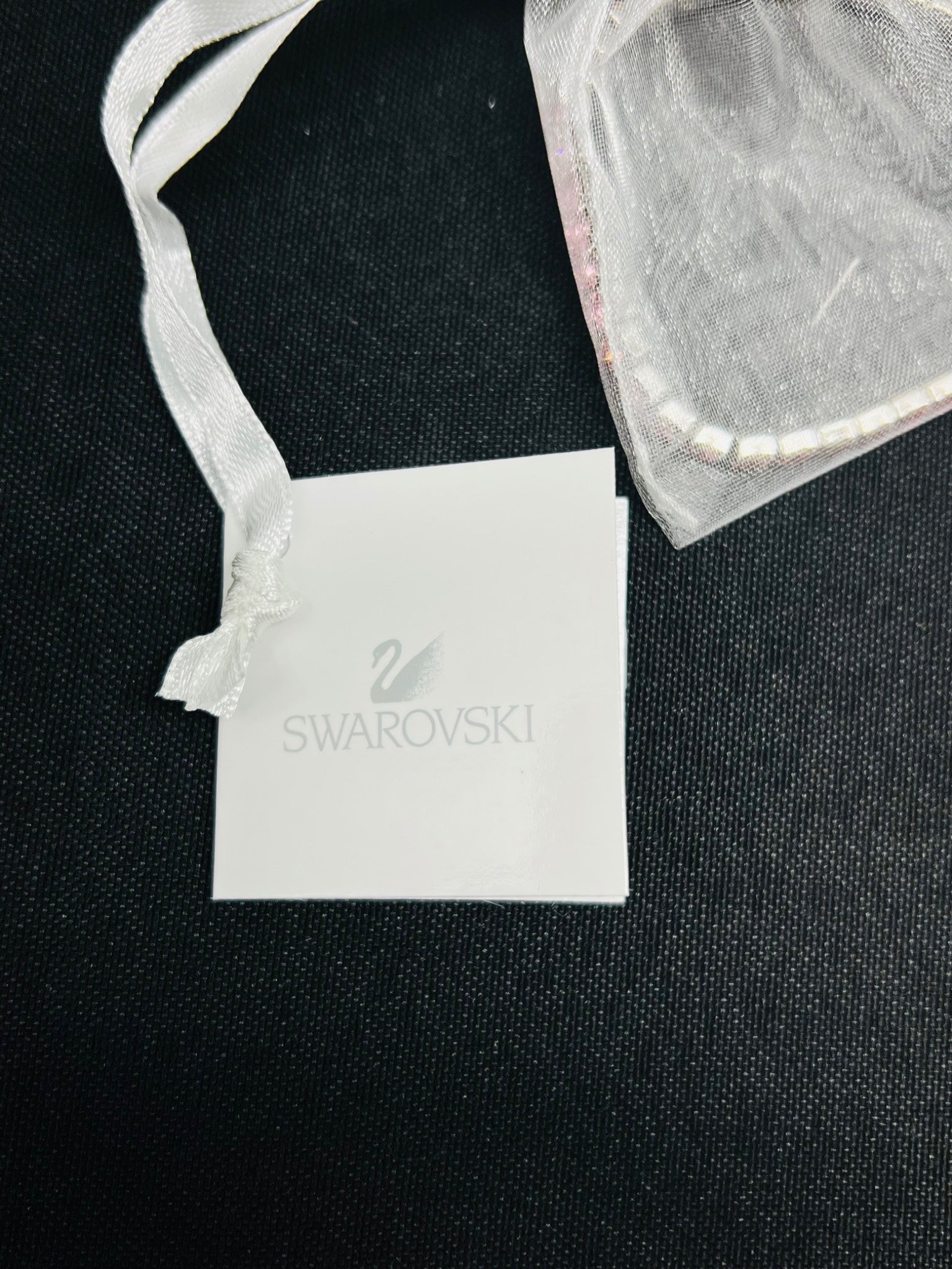 Swarovski jewelry tag on a black background